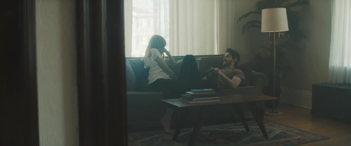 A couple on the couch together in a living room