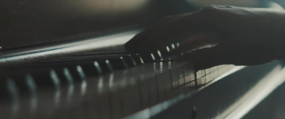 Man plays the piano indoors