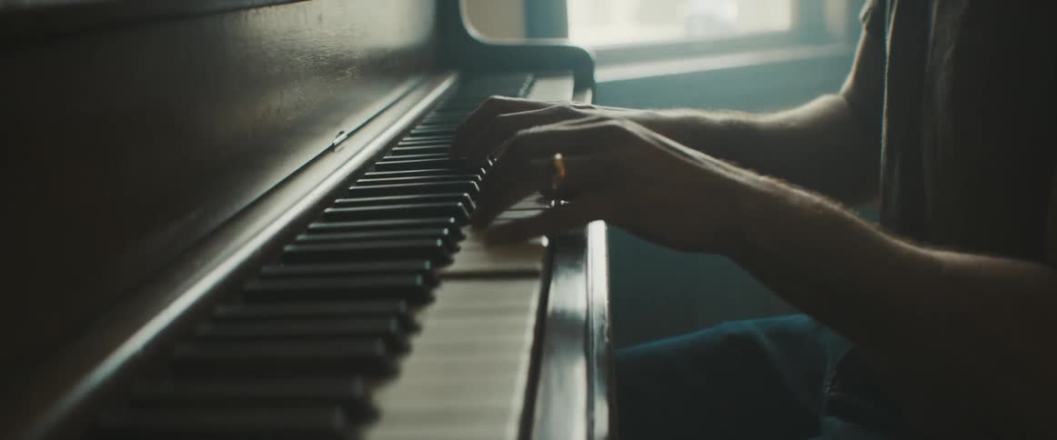 A man sits and plays the piano