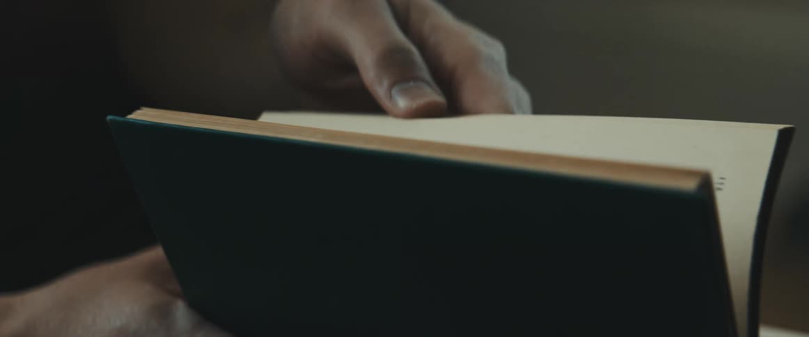 A white male riffles through a book