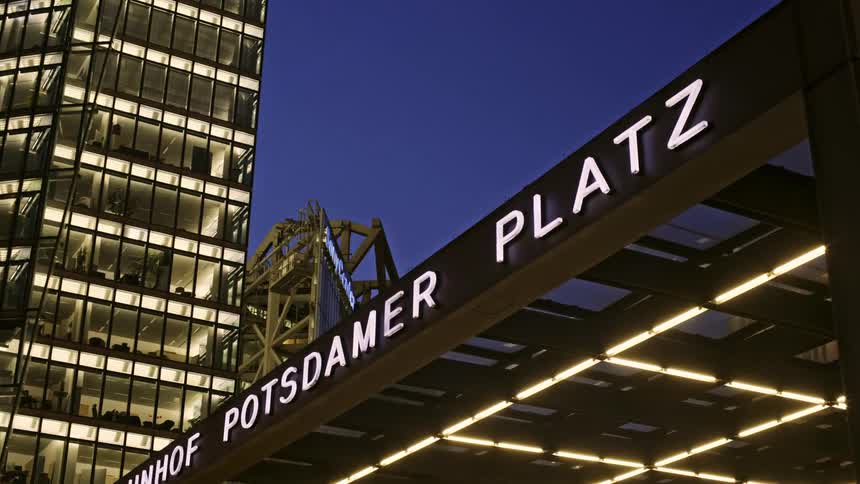 The berlin bahnhof potsdamer platz railway station with glowing lights and sign