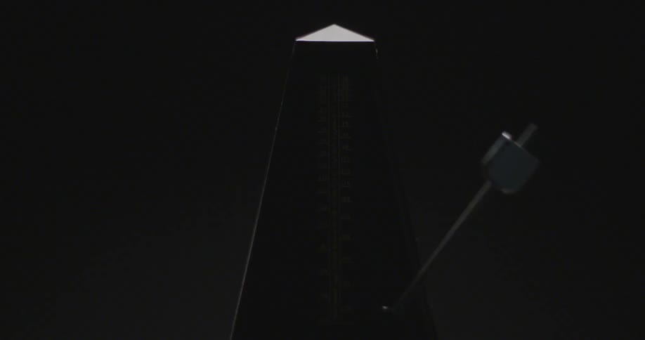 A metronome ticks back and forth