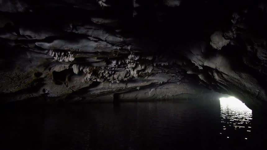 Sunlight shining reflecting off the water running through a cavern