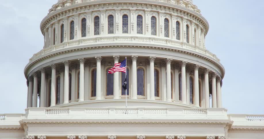 The american flag flies over the us capitol building