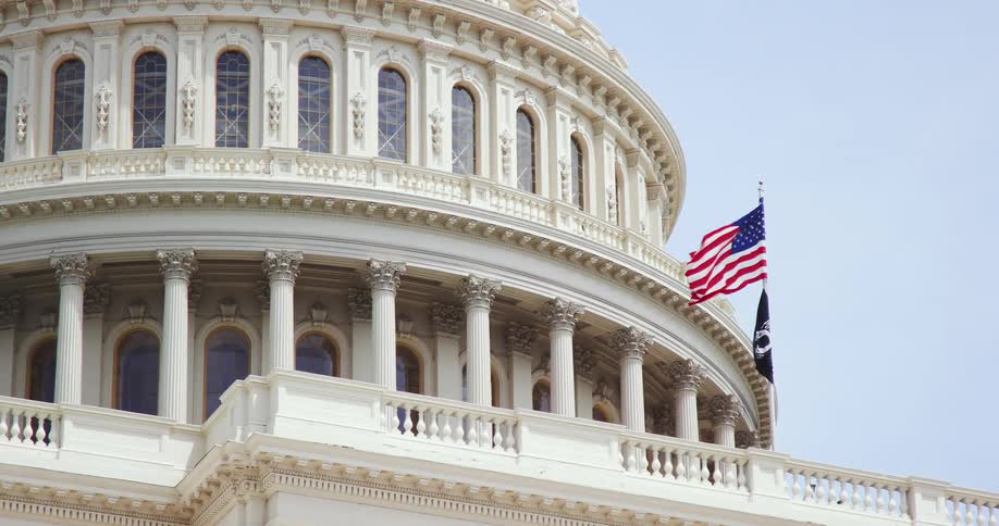 A government building with flags in front of it