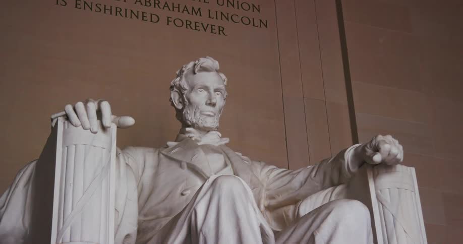 A statue of abraham lincoln sits in his memorial in washington dc