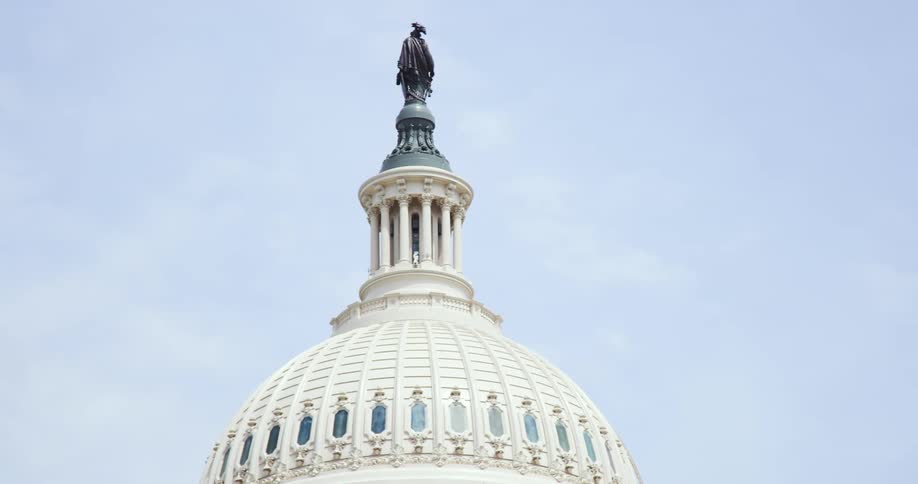 A statue stands atop a domed building