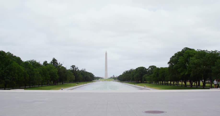 The washington monument stands tall at the end of the national mall