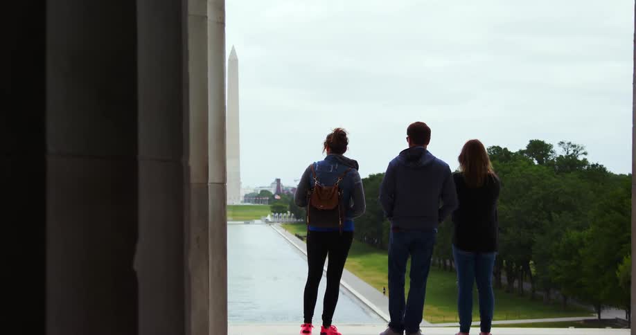 A group of friends are standing outdoors in a city