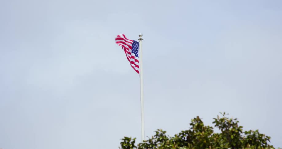 A united states flag blowing in the wind