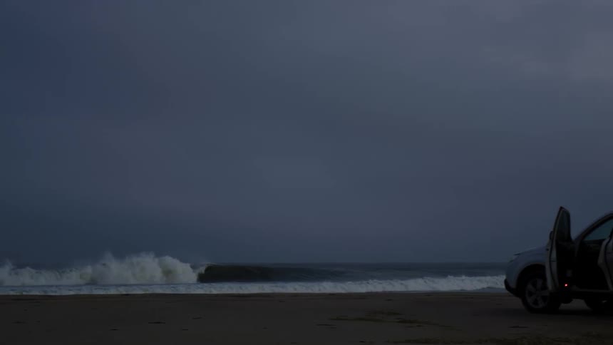 The car sits on the beach