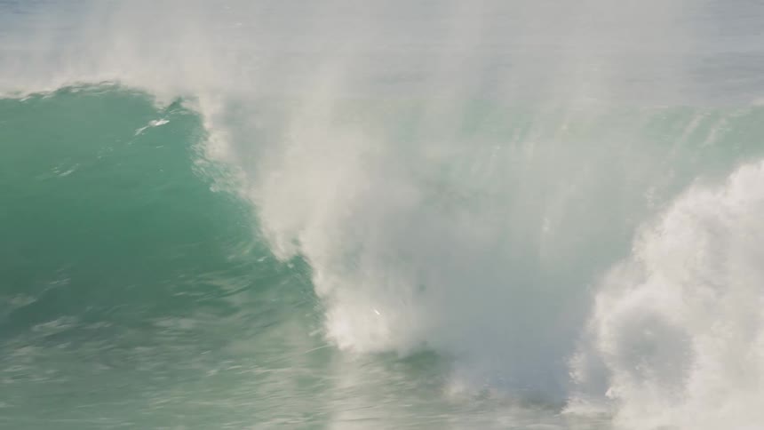 Man surfs a wave as it comes towards land
