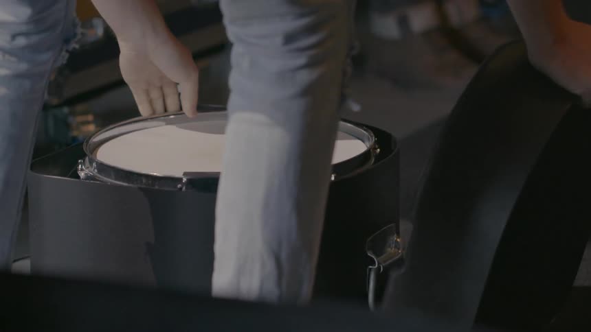 Person taking a drum out of its case