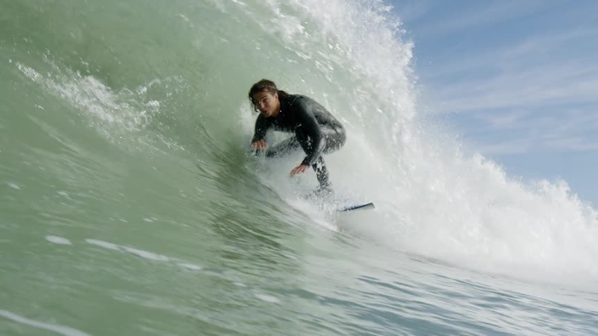 Man surfs a wave as it comes towards land