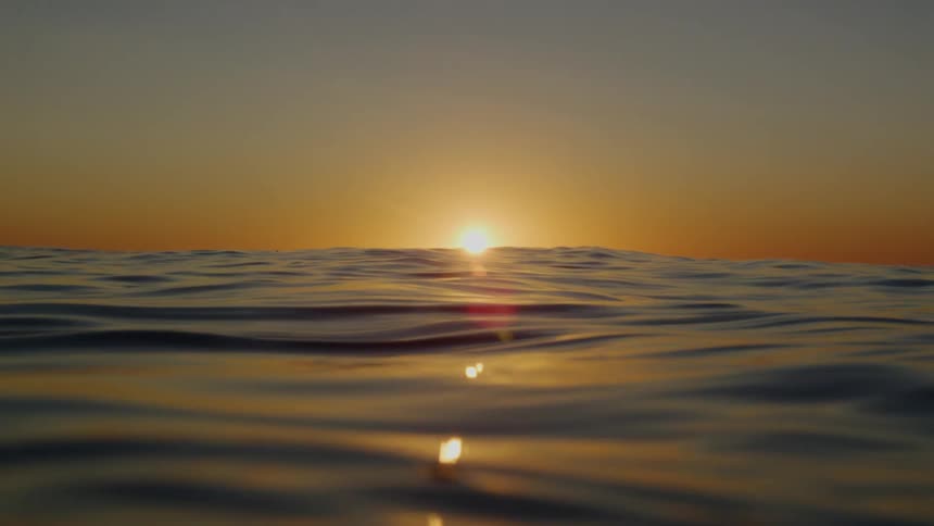 The ocean with the sky and the sunset in the background