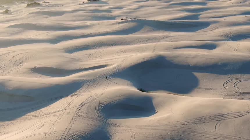 Aerial view of a man walking in the desert