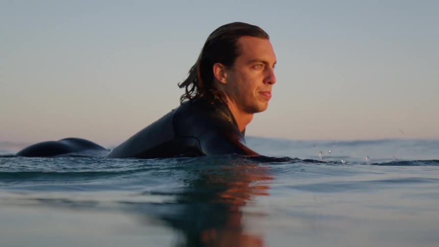 The man swims in the ocean