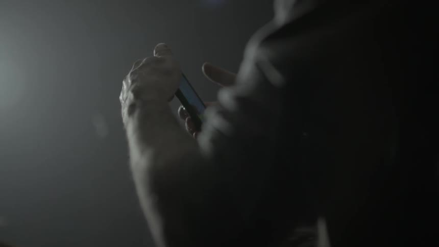A person is holding and tapping on a smartphone