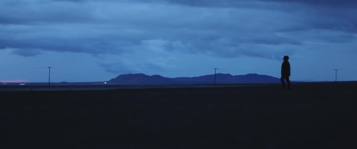 A man is walking in the horizon