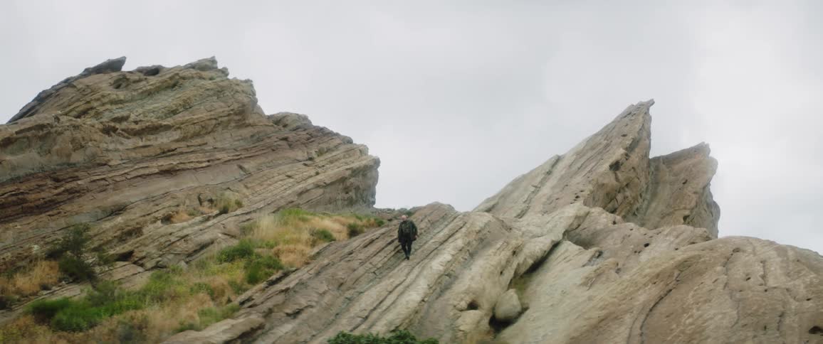 Person hiking down a steep slope in the canyon