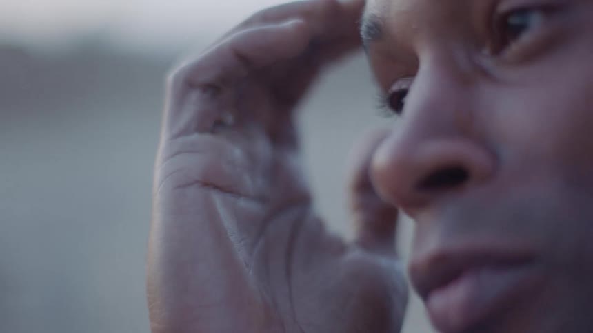 A woman wipes her tears as she cries