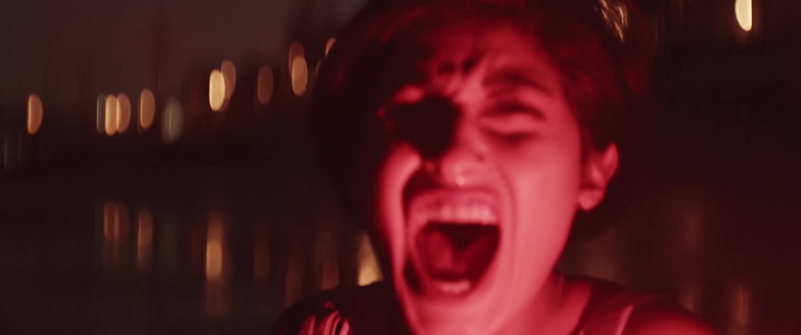 A woman touching her hair then yelling out in anger