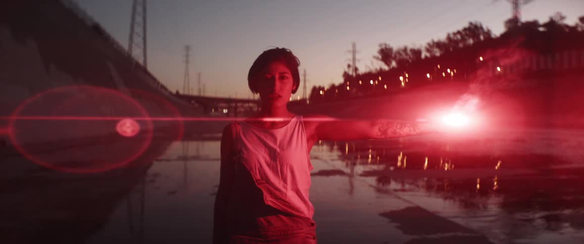 Woman holding a flaming torch steps forward and yells
