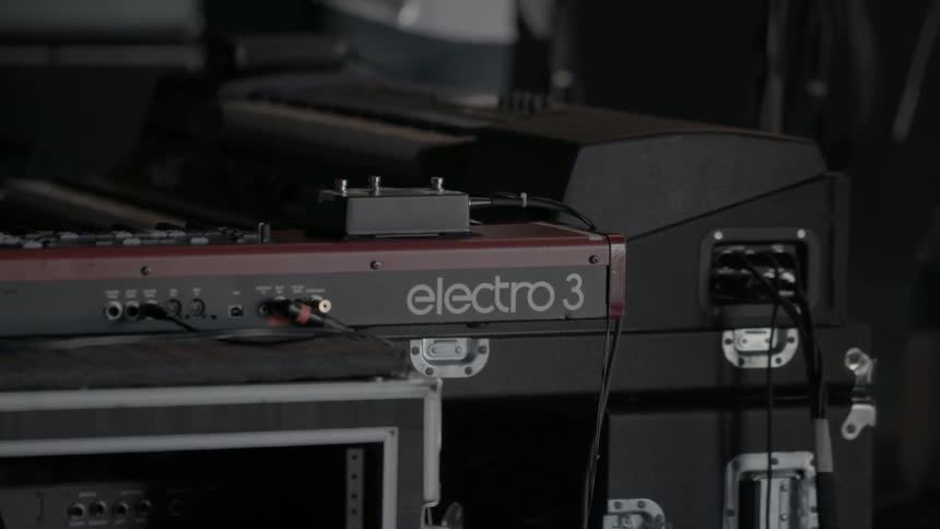 A man runs a cord from audio equipment