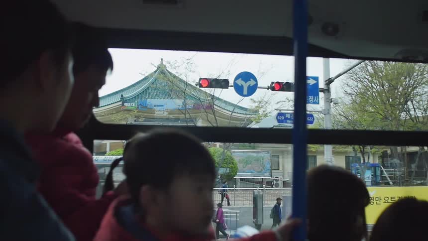 People are riding a bus in a city