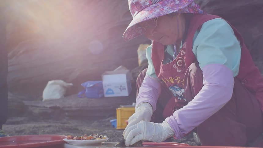 A woman slicing meat outdoors