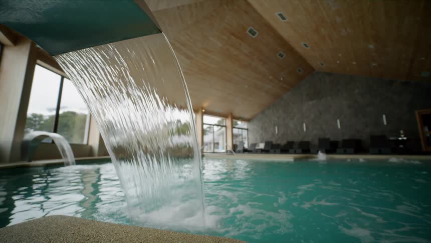 Water pours into a swimming pool from a recirculation device
