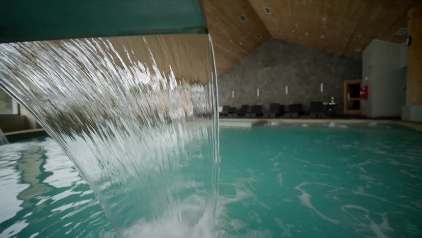 Water pours into an indoor swimming pool