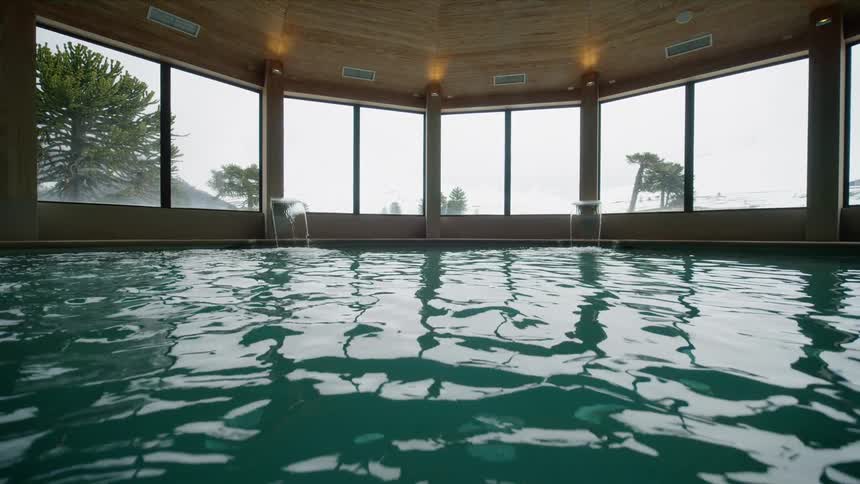 Indoor pool water gently moving during a foggy day