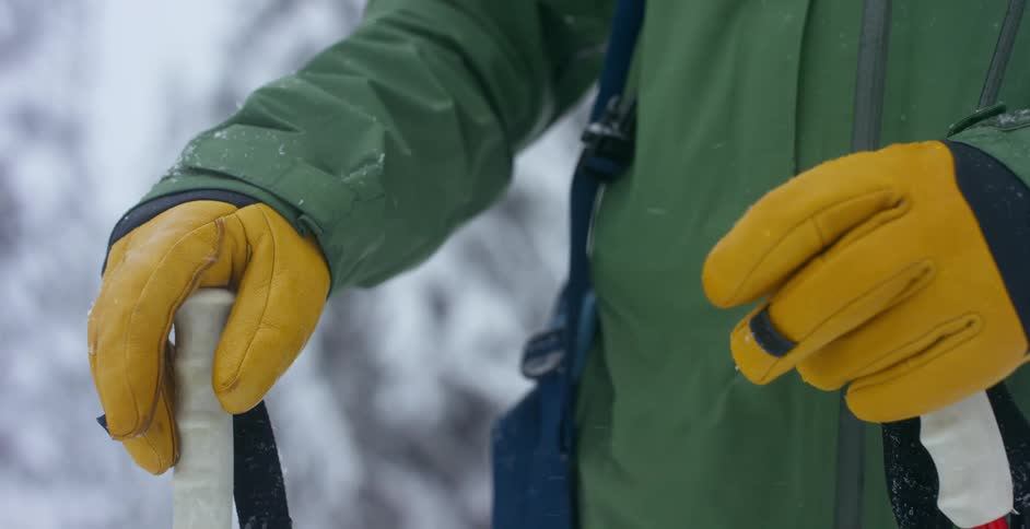 A skier's gloved hands outside in the snow
