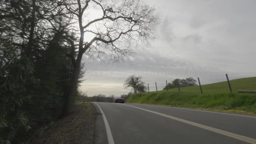 A car driving down a rural road