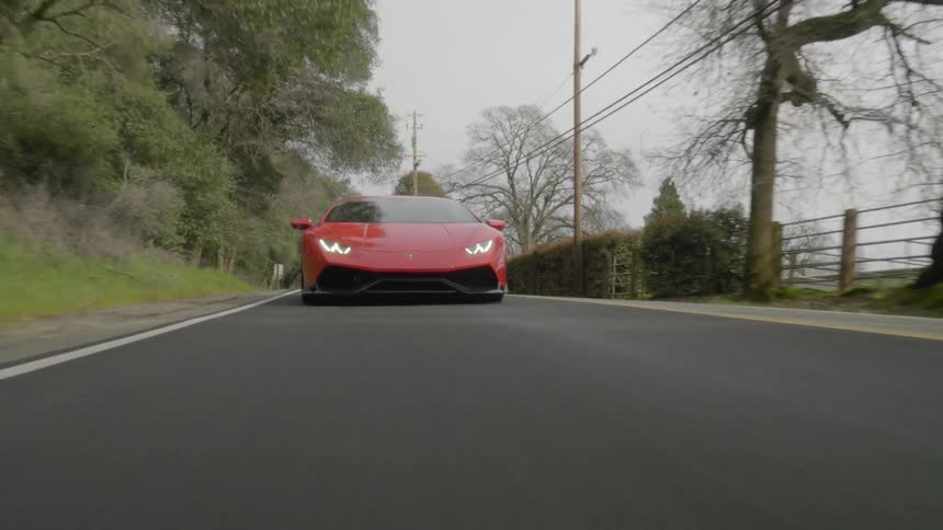 A sports car speeds through the country