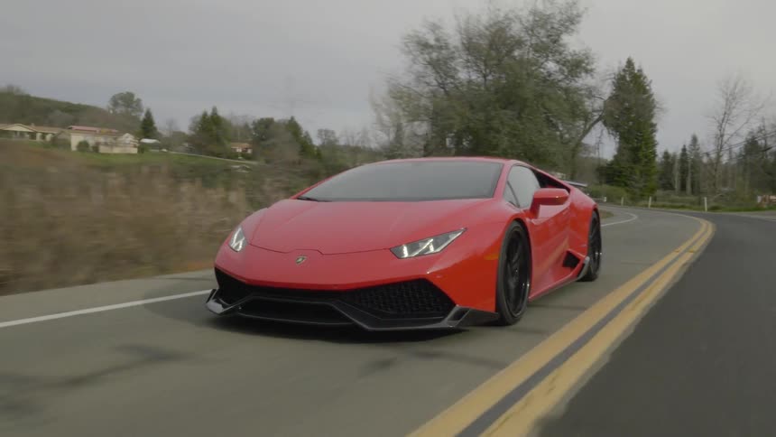 A sports car speeds through the country