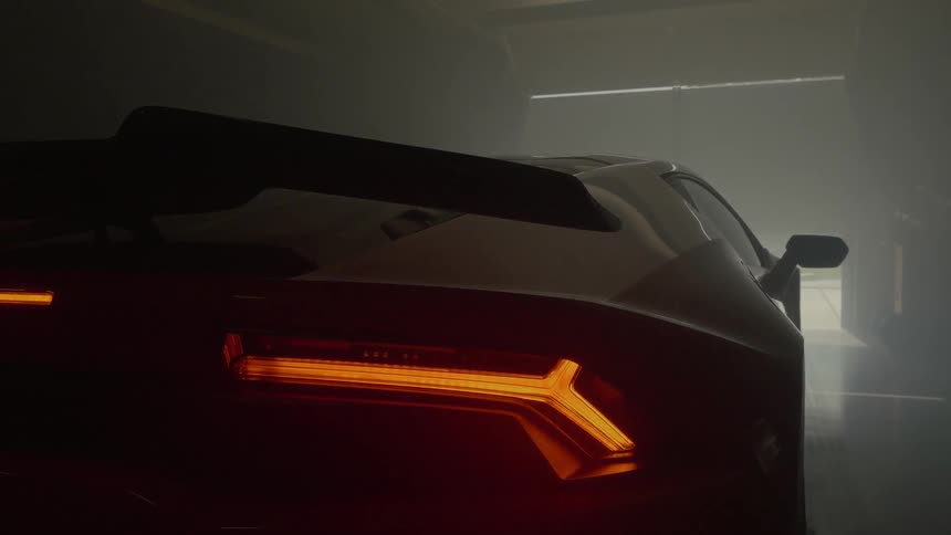 A sports car parked in a garage as the door closes