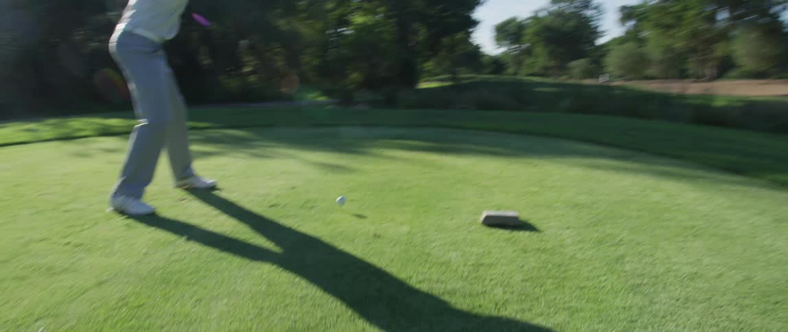 Man hitting golf ball with golf club
