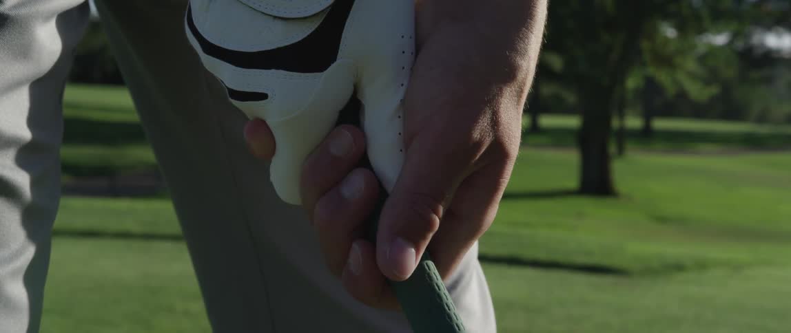 A man grips a golf club