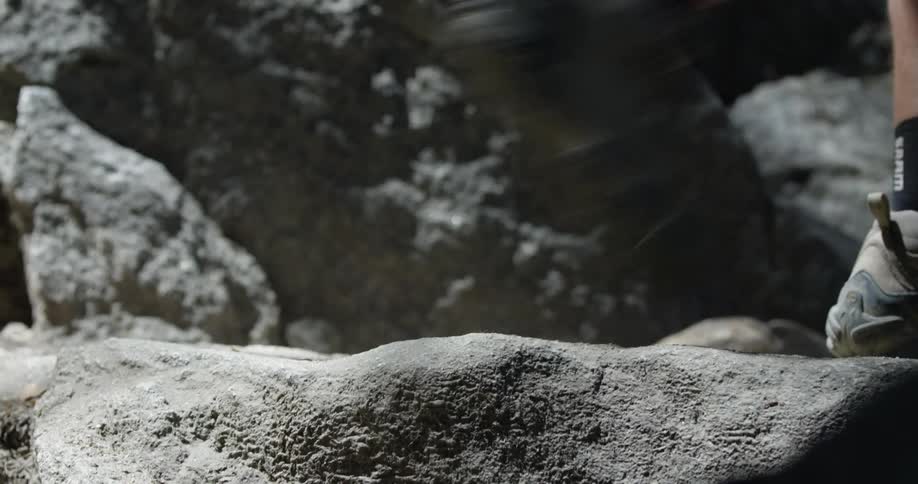Feet climb up on rocks