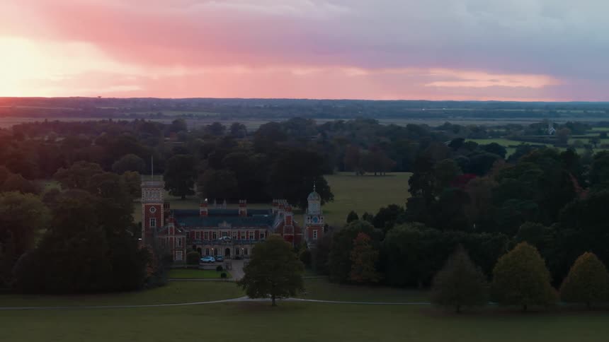 A large manor in a rural area in the evening
