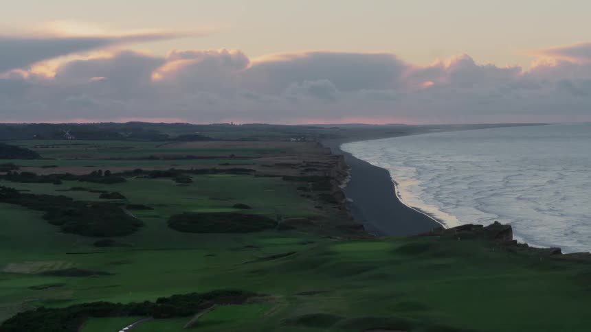 The green plains lead to the shore