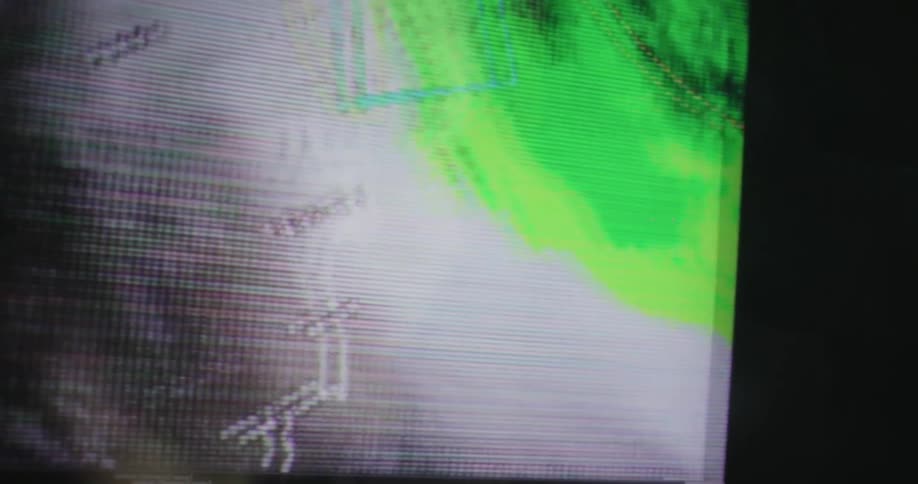 The monitor is showing a storm on a map