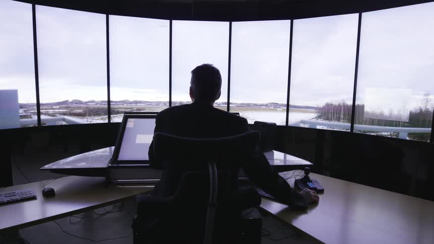 A row of windows light up with a view in an office