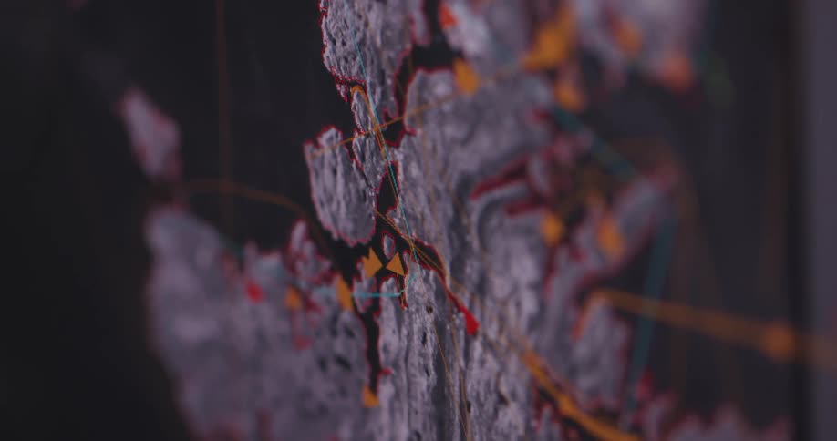 Orange triangles move over a digital map on paths