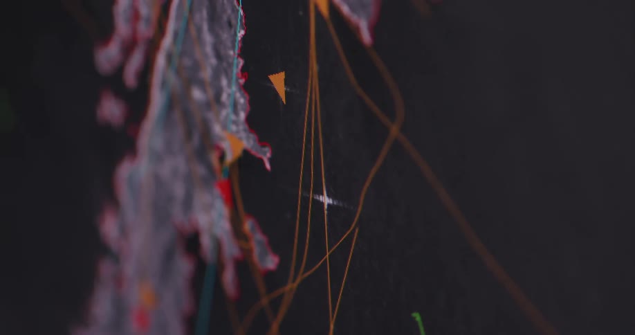 A screen shows a map with lines and colored triangles flashing and moving