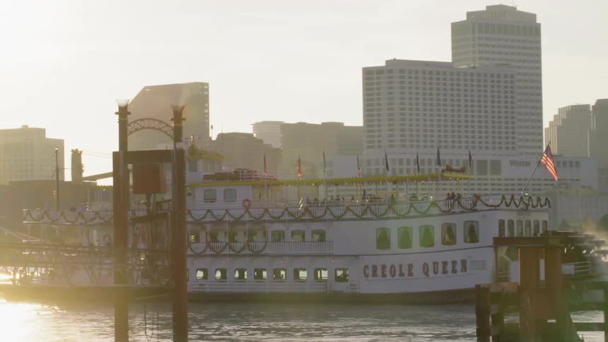A ferry boat runs along the city river with passengers