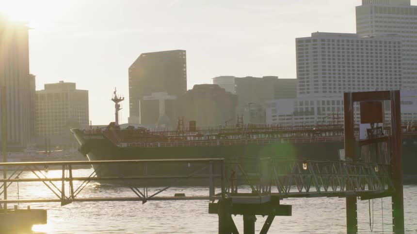 Aerial footage of a large cargo ship coming into port of a city