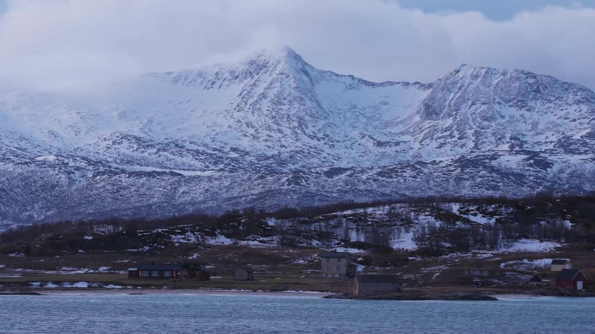 Buildings at the base of a mountain range